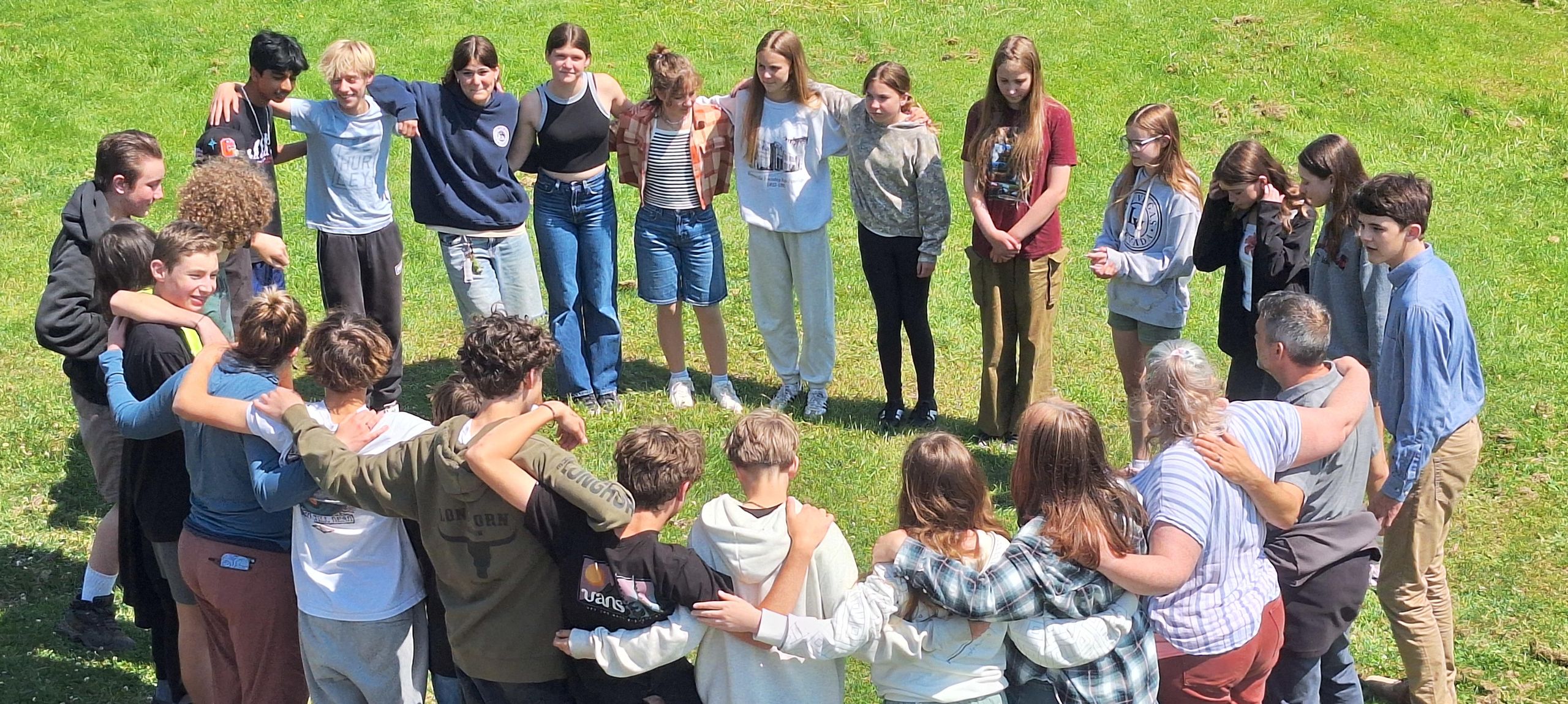 CMMS students gathered in a circle on the lawn